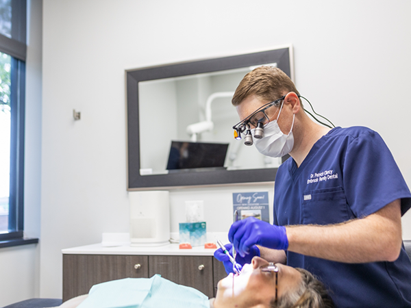 Woman smiling during dental checkup and teeth cleaning visit