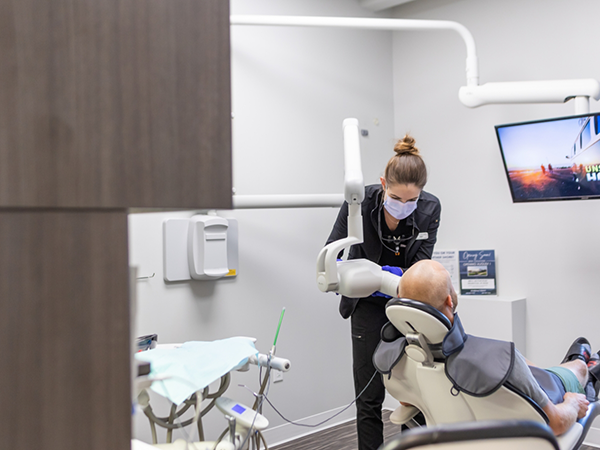 Man smiling during biannual dental checkup