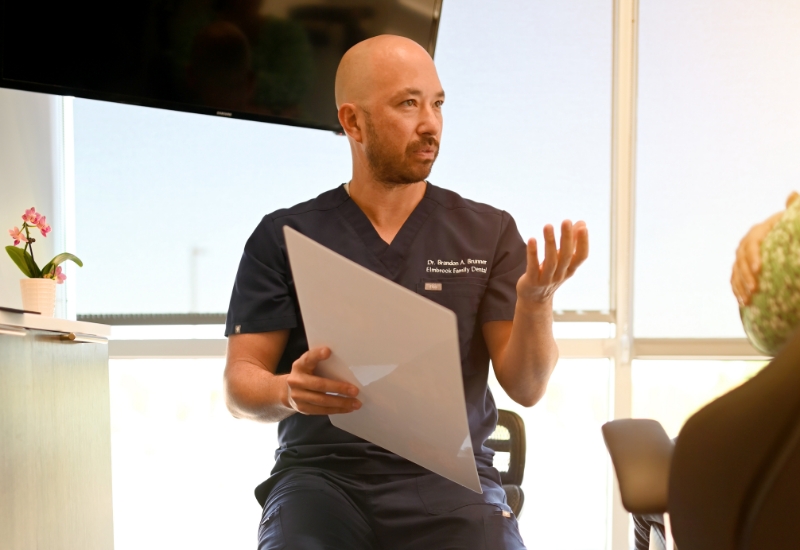 dentist speaking with patient in exam room