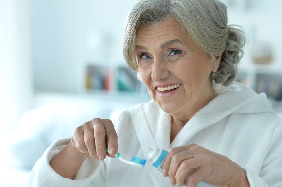 A woman brushing her teeth.